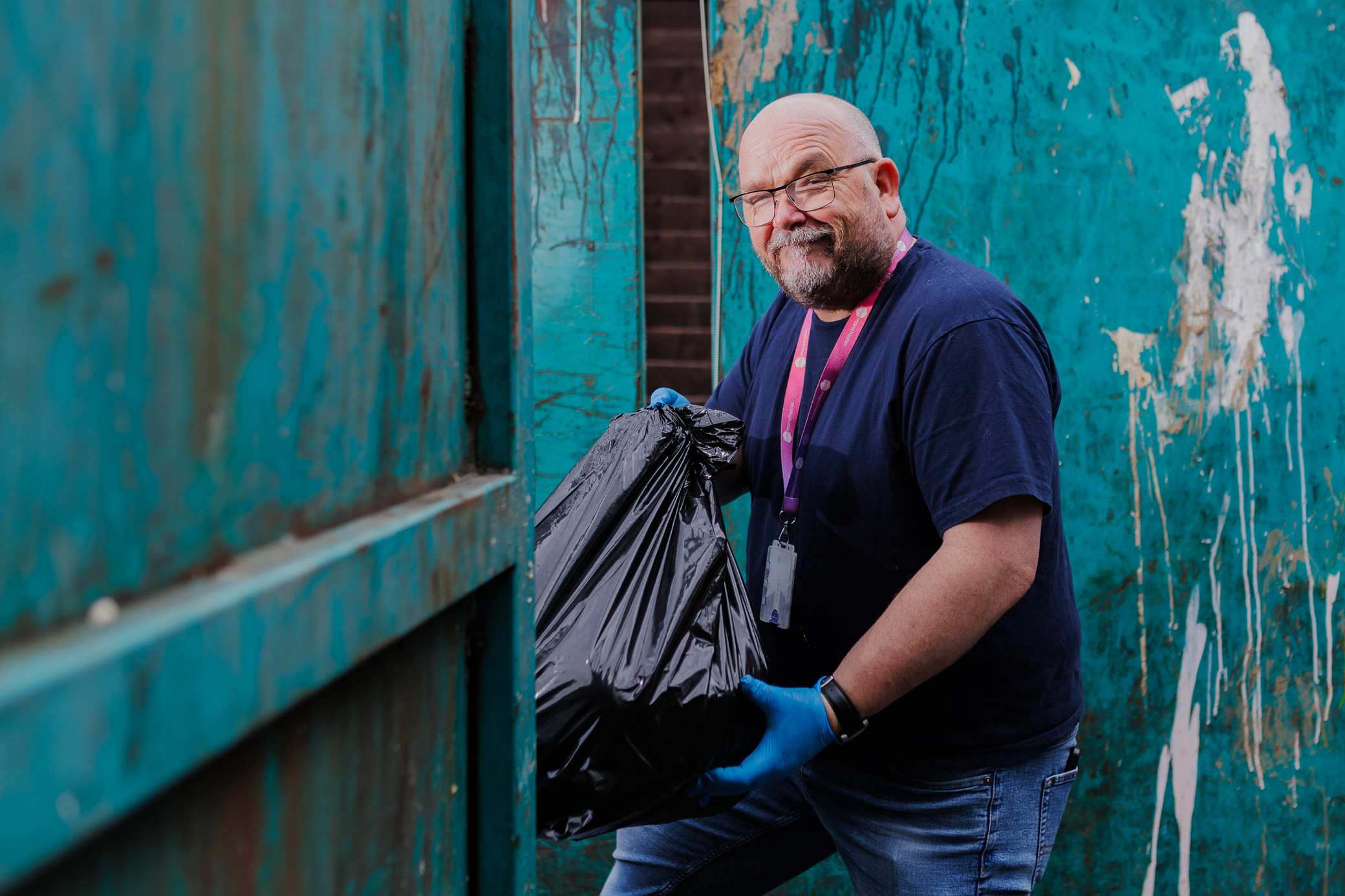 Customer holidng a rubbish bag at a clean up