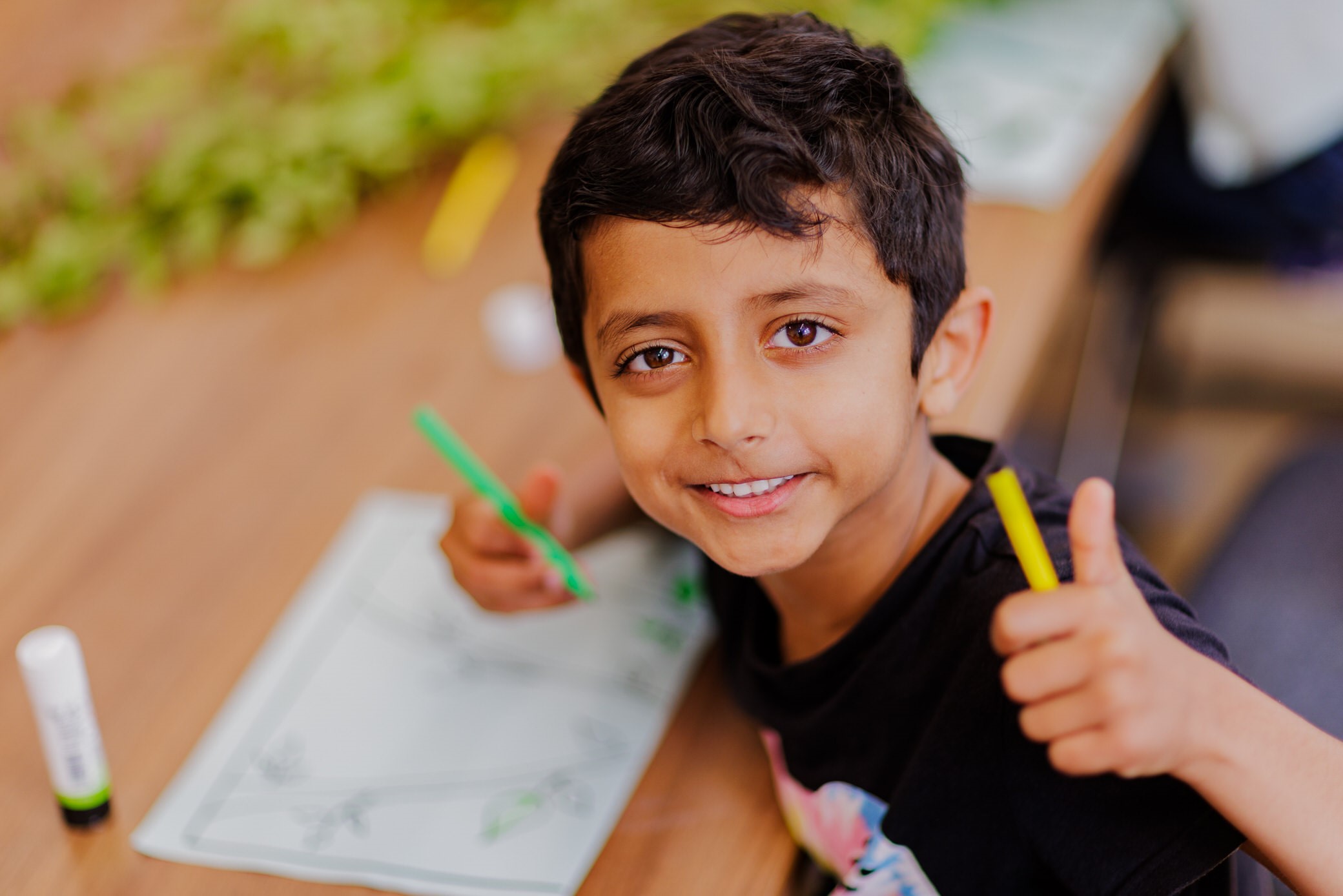Child doing colouring at a community fun event