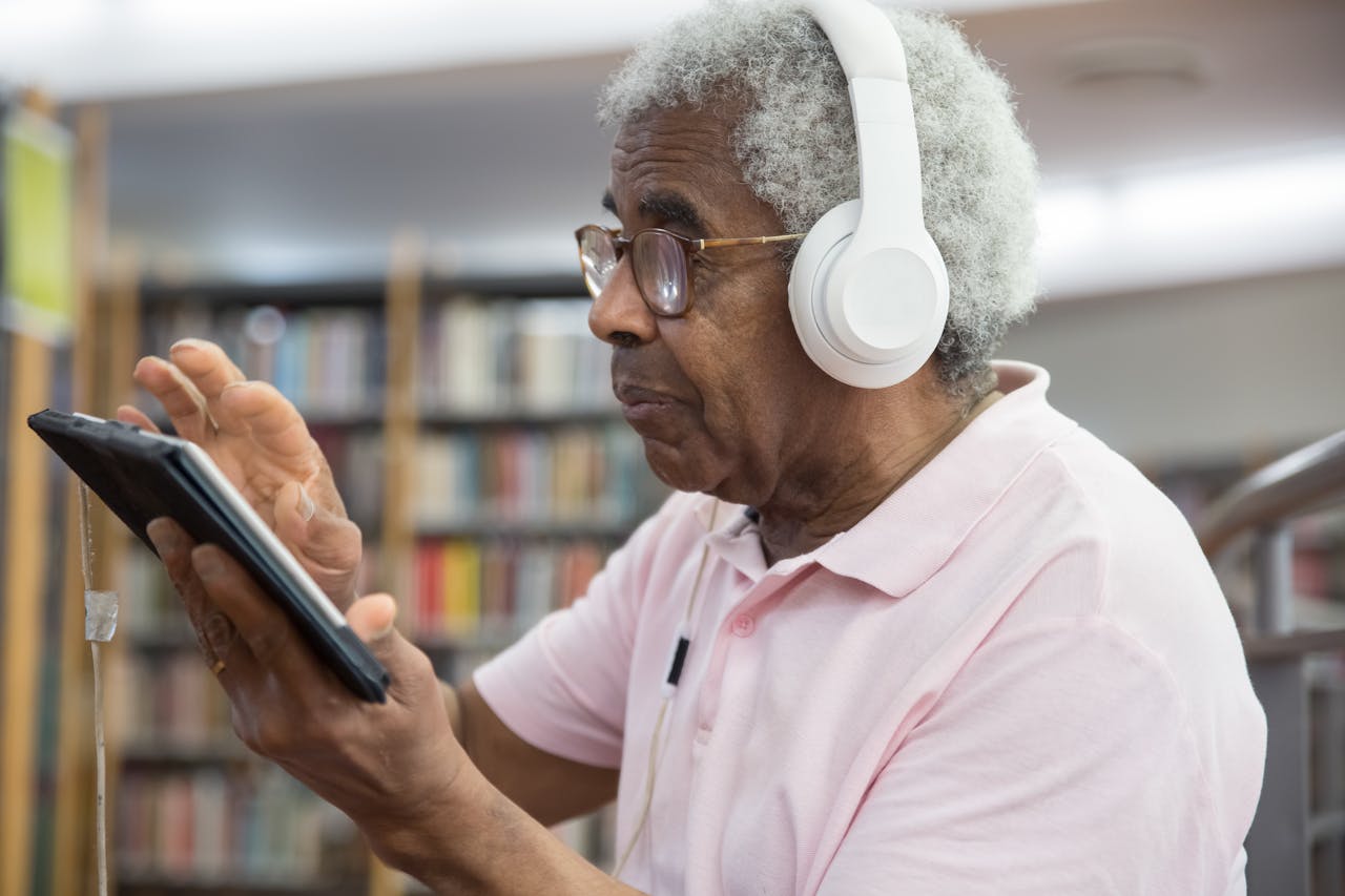 Person wearing headphones using a tablet