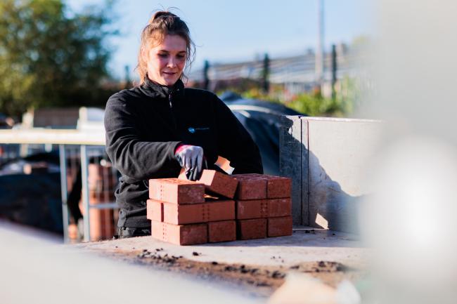 Woman Laying Bricks