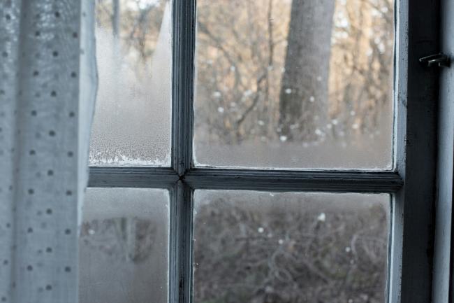 An image of a window with condensation appearing on it.