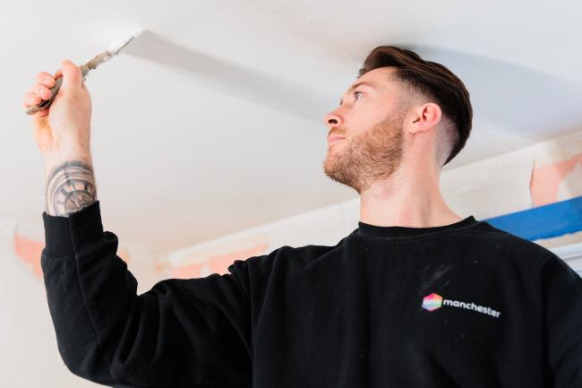 A One Manchester colleague decorating hte ceiling.