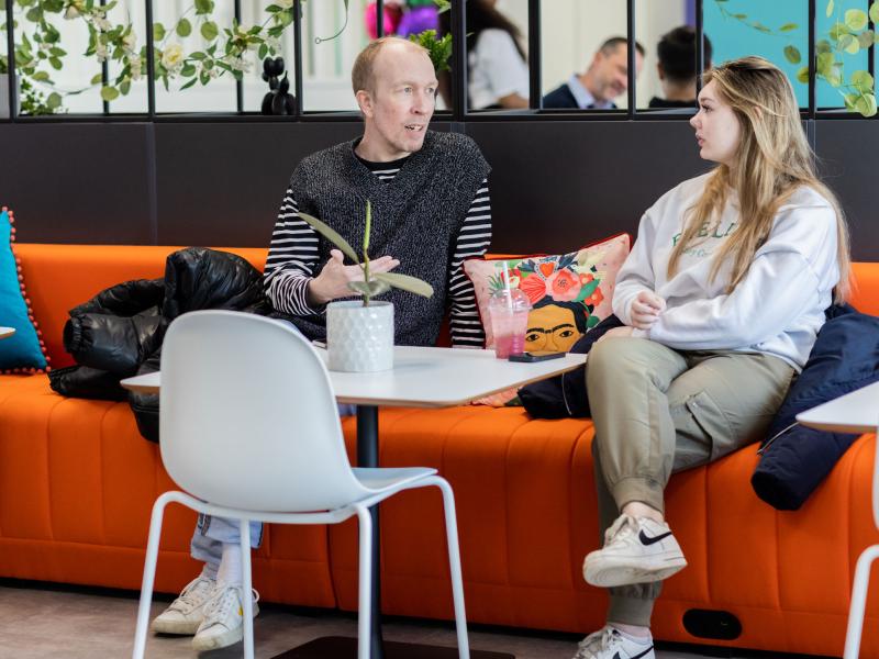a man and woman chatting in an office