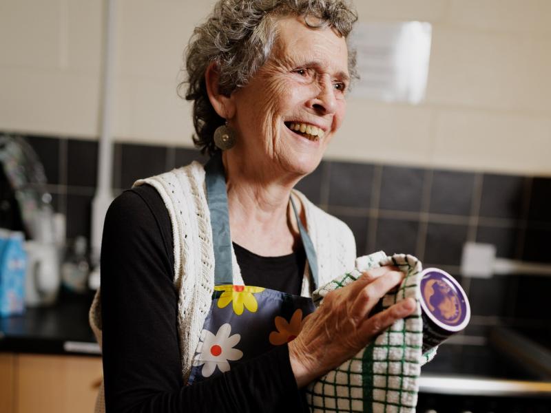 Person washing up in community kitchen