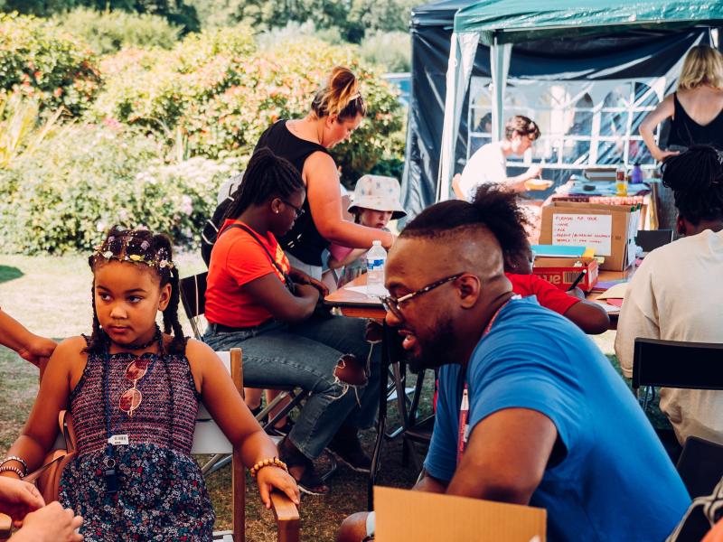 Customer and child sitting down doing an activity at an event