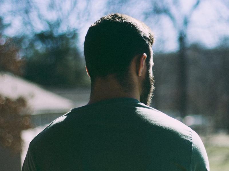 Person standing with their back to the camera