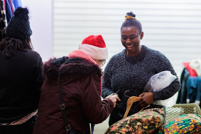 An image of a customer and colleague at Gorton Christmas Lights Switch on event laughing together
