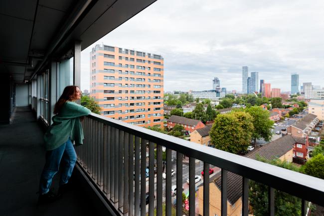 Woman looking over the edge of a building