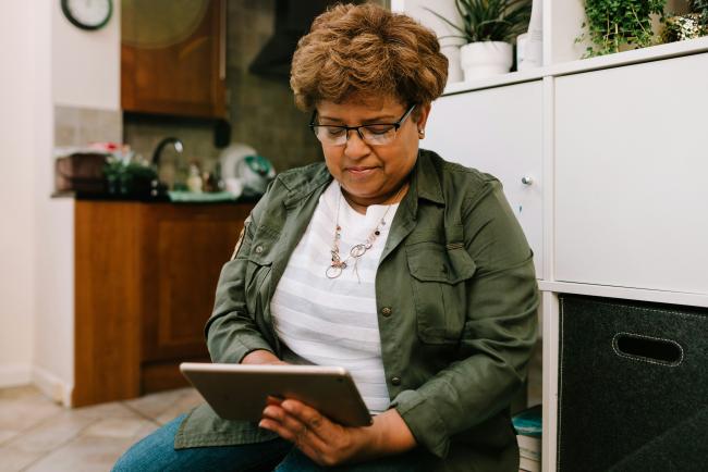 Person using a tablet sitting down