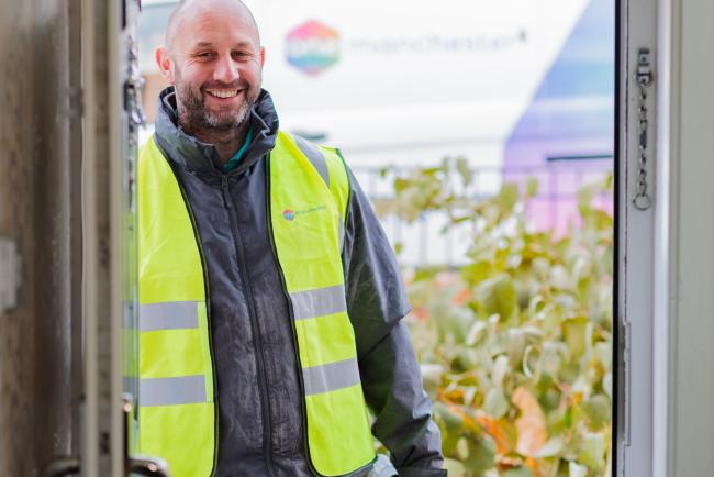 A tradesperson stood in a doorway 